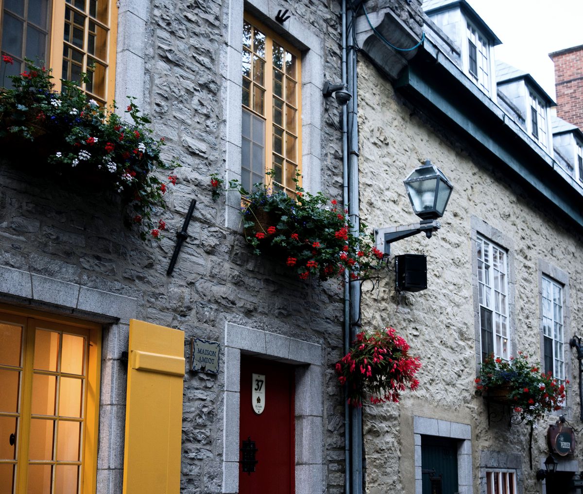 Maisons de pierre de la rue du Petit-Champlain, fenêtres à carreaux, jardinières fleuries et lanterne